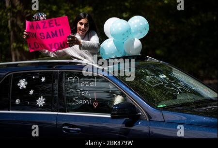 Potomac, United States. 02nd May, 2020. Friends congratulate Sami Snow with a surprise drive-by Bat Mitzvah celebration in Potomac, Maryland on Saturday, May 2, 2020. The family held a small ceremony at the home with the Rabbi officiating online followed by a surprise drive by Mitzvah celebration due to the Coronavirus (COVID-19) social-distancing requirements. Photo by Kevin Dietsch/UPI Credit: UPI/Alamy Live News Stock Photo