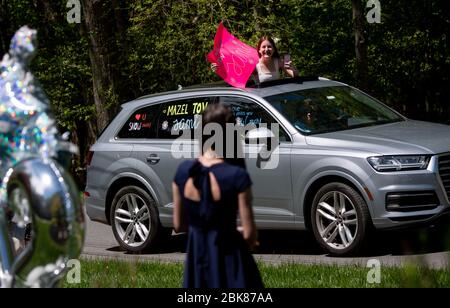 Potomac, United States. 02nd May, 2020. A friend congratulates Sami Snow (foreground) during a surprise drive-by Bat Mitzvah celebration in Potomac, Maryland on Saturday, May 2, 2020. The family held a small ceremony at the home with the Rabbi officiating online followed by a surprise drive by Mitzvah celebration due to the Coronavirus (COVID-19) social-distancing requirements. Photo by Kevin Dietsch/UPI Credit: UPI/Alamy Live News Stock Photo