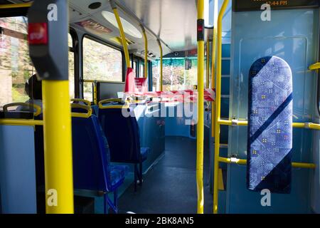 Taped off area on buses preventing passengers from sitting next to bus drivers. Stock Photo