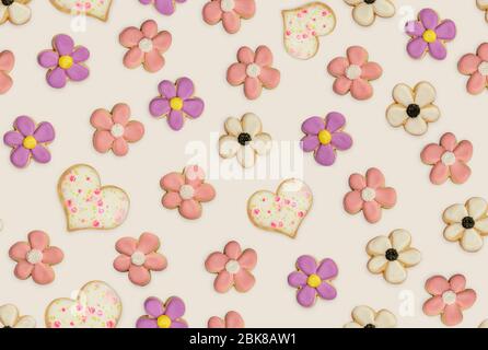 Seamless repeating pattern with glazed cookies in the shape of flowers.and hearts. Stock Photo