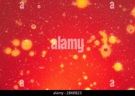 Yellow and white bubbles on a red background. Abstract natural texture made of mixed colors. Colorful pattern with bubbles Stock Photo