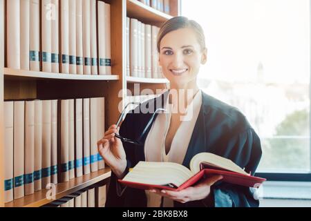 Lawyer working on a difficult case reading in the library Stock Photo