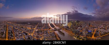 Dec 24, 2019 - Paris, France: Panoramic aerial shot of Neuilly Levallois la defense skyscraper complex with Eiffel tower la seine during sunset hour Stock Photo