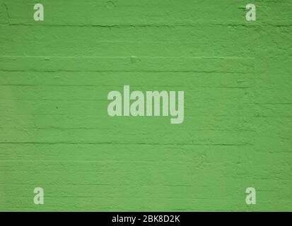 Textured concrete wall painted green Stock Photo