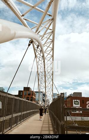 Denver, Colorado - May 1st, 2020:  Highland Bridge, a pedestrian bridge connecting the LoHi neighborhood to Downtown Denver.  Lower Highlands. Stock Photo