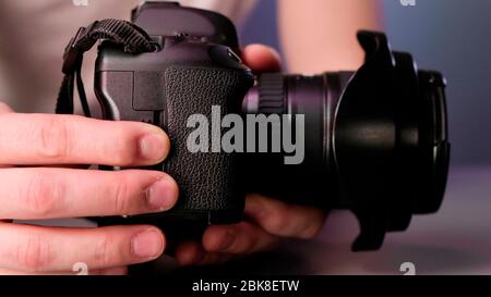 Hand removing memory card from slot of camera Stock Photo