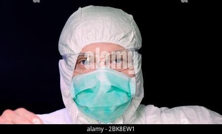 Doctor take off his glasses on black background. Stock Photo