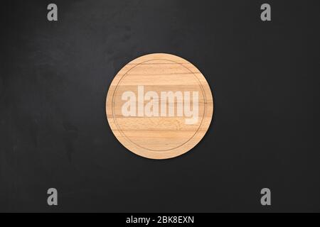 Round wooden tray or cutting board on table. Top view Stock Photo