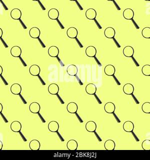 Seamless pattern of magnifiers on a yellow background. Close up. Stock Photo