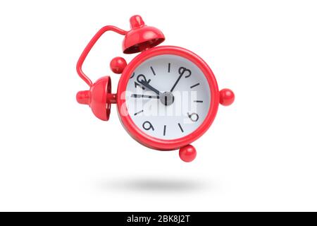 Red analog clock on a white background. Isolated. Close up. Stock Photo