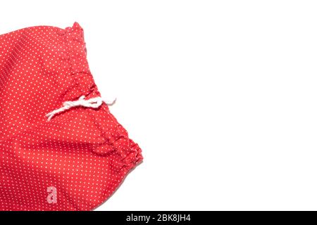 Kid's red with white polka dot pattern pants isolated on white background. Stock Photo