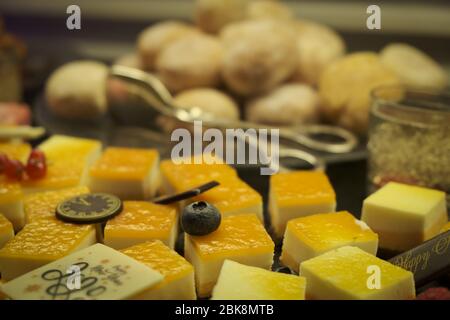 Close up of dessert buffet on new year 2020. Pieces of lemon cake. Petit four. Sweet cakes and biscuits for dessert. Stock Photo