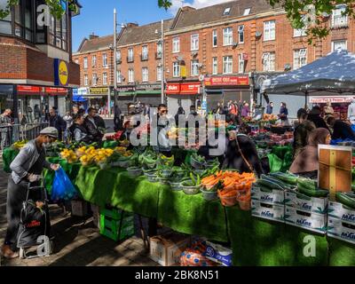 Walthamstow. London. UK. May the 2nd, 2020. View of people queuing and shopping vegetables at the Street Market during the Lockdown. This is the longe Stock Photo