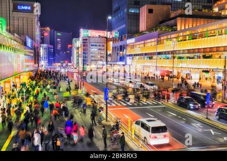 Tokyo, Japan - 31 Dec 2019: Busy street crossing near Shinjuku station in Toky at night with bright lights. Stock Photo