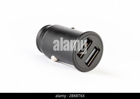 horizontal view of a black color car lighter charger with dual usb socket isolated on white background Stock Photo