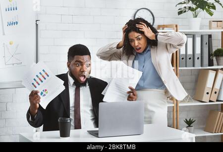 Stressed African American colleagues missing project deadline at office Stock Photo