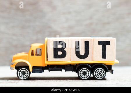 Truck hold letter block in word but on wood background Stock Photo
