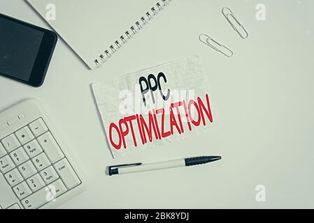 Word writing text Ppc Optimization. Business photo showcasing Enhancement of search engine platform for pay per click Flat lay above computer mobile p Stock Photo