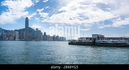 View of Star Ferry Pier in Tsim Sha Tsui with Hong Kong Island Cityscape Stock Photo