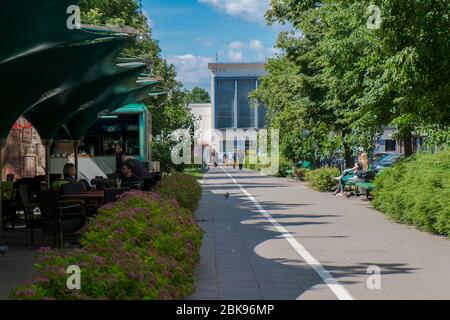 A view along the pedestrian median of Vokiečių street, lined with outdoor cafes in the summer. In Old Town, Vilnius, Lithuania. Stock Photo