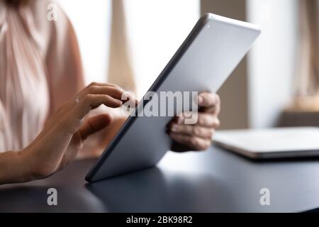 Close up female hands holding computer tablet, using gadget Stock Photo