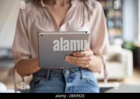 Close up young woman using computer tablet at home Stock Photo