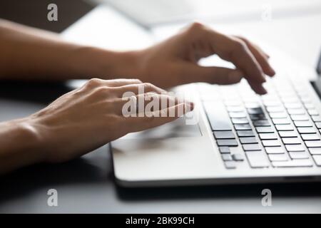 Close up female hands typing on laptop keyboard Stock Photo