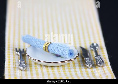 table setting on white and yellow checkered tablecloth Stock Photo