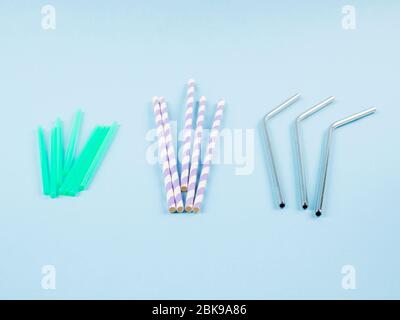 Different material drinking straws on pastel blue Stock Photo