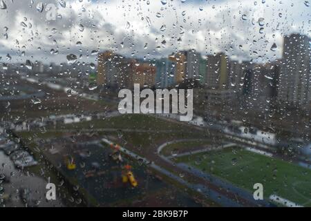 Waterdrops on a glass surface windows with cityscape background Stock Photo