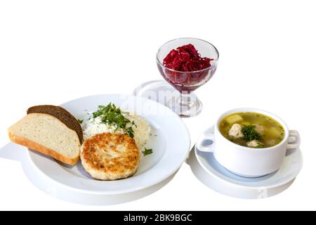 Business lunch. Soup, salad, cutlet with rice and bread isolated on white background Stock Photo