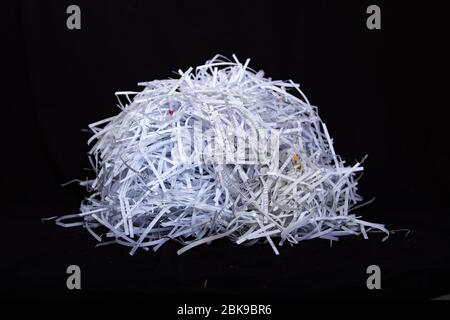 bunch of paper shredded with a shredder, black background Stock Photo