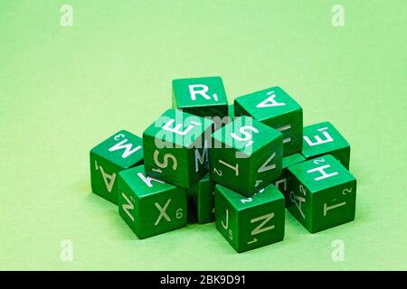 green wooden cubes with different letters on, can be used in games Stock Photo