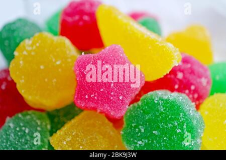 Closeup Vivid Pink Star Shaped Sugar Coated Jelly Candy on Candies Pile Stock Photo