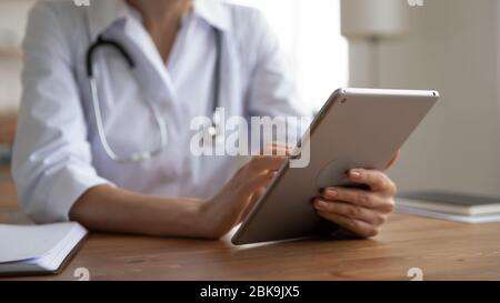 Female doctor holding using modern digital tablet, close up view Stock Photo
