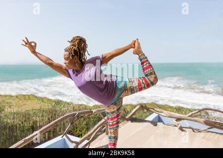 Young Beautiful Sporty Woman In Comfortable Clothing Doing Yoga Asana On  Sea Beach Near Water Girl Practicing Exercises Health Concept Colorful  Picture Stock Photo - Download Image Now - iStock