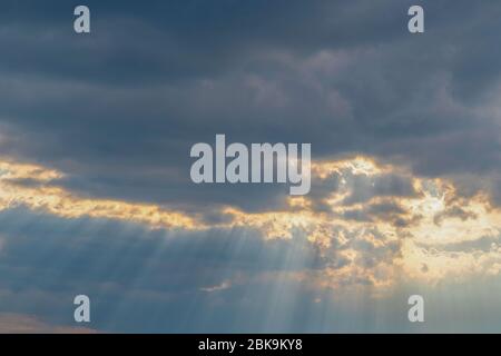 The rays of the sun shine through clouds Stock Photo