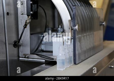 Automatic tape to create packaging and filling of medicines. Ampoule filling and sealing machine, equipment in pharmaceutical industry. Stock Photo