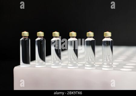 Quality Control vials for injection. Individual checks vial under a ...