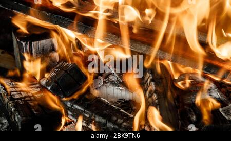 Burning coals fire from them in the grill Stock Photo