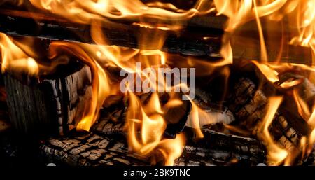 Burning coals fire from them in the grill Stock Photo