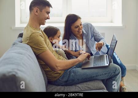 Happy family uses online laptop at home Stock Photo