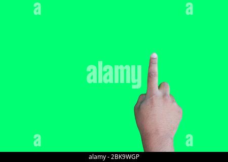 Hand of a man with finger pointing on the green screen background Stock Photo