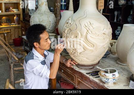 Jingdezhen, Jiangxi province / China - May 29, 2014: Porcelain Craftsman working in the Pottery workshop in Jingdezhen, China, city famous for its por Stock Photo