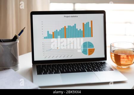Empty workplace with laptop with financial project Stock Photo