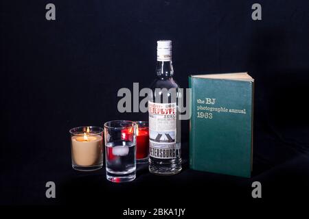 Bottle of drink and a Bristish Journal  photographic annual 1963 book against a black background Stock Photo