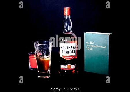 Bottle of drink and a Bristish Journal  photographic annual 1963 book against a black background Stock Photo