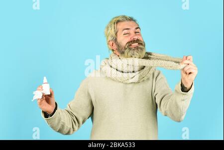 immune system help during epidemic. healthcare in winter. best cold remedy. helpful nasal spray. man use nasal drops during course of disease. happy man says no to flu. coronavirus from china. Stock Photo