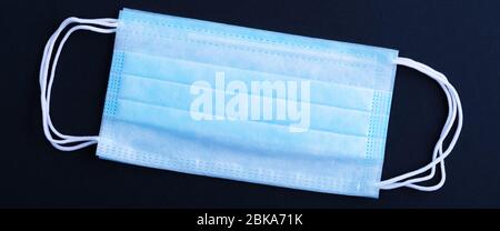 Medical mask surgical protective virus, flu, disease, textile filter. Isolated on a black background. Stock Photo