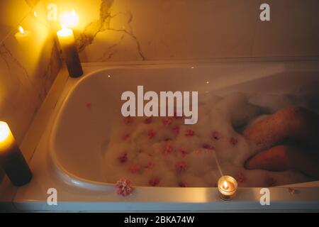 Bathtub filled with foam and rose petals prepared for romantic date Stock  Photo - Alamy